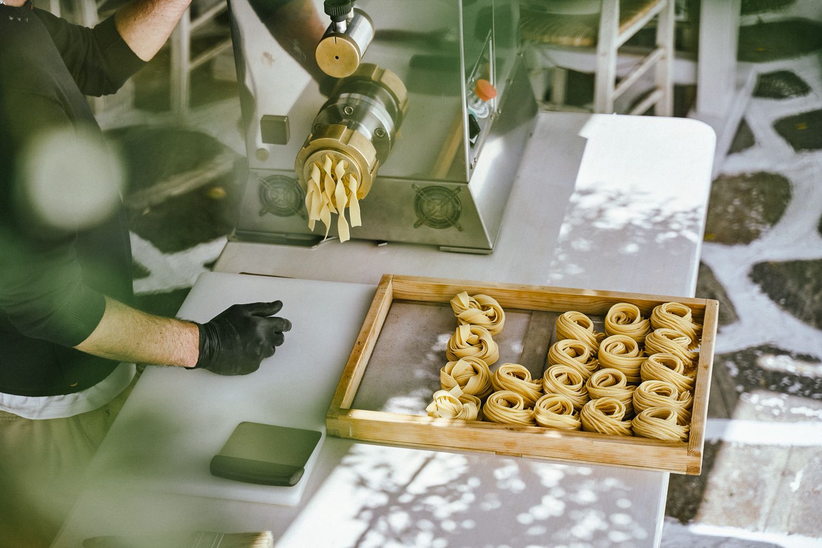 Fresh pasta nests on wooden tray